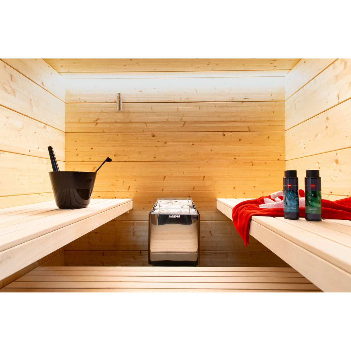 Harvia KIP W wall-mounted sauna heater seen beside the sauna bench