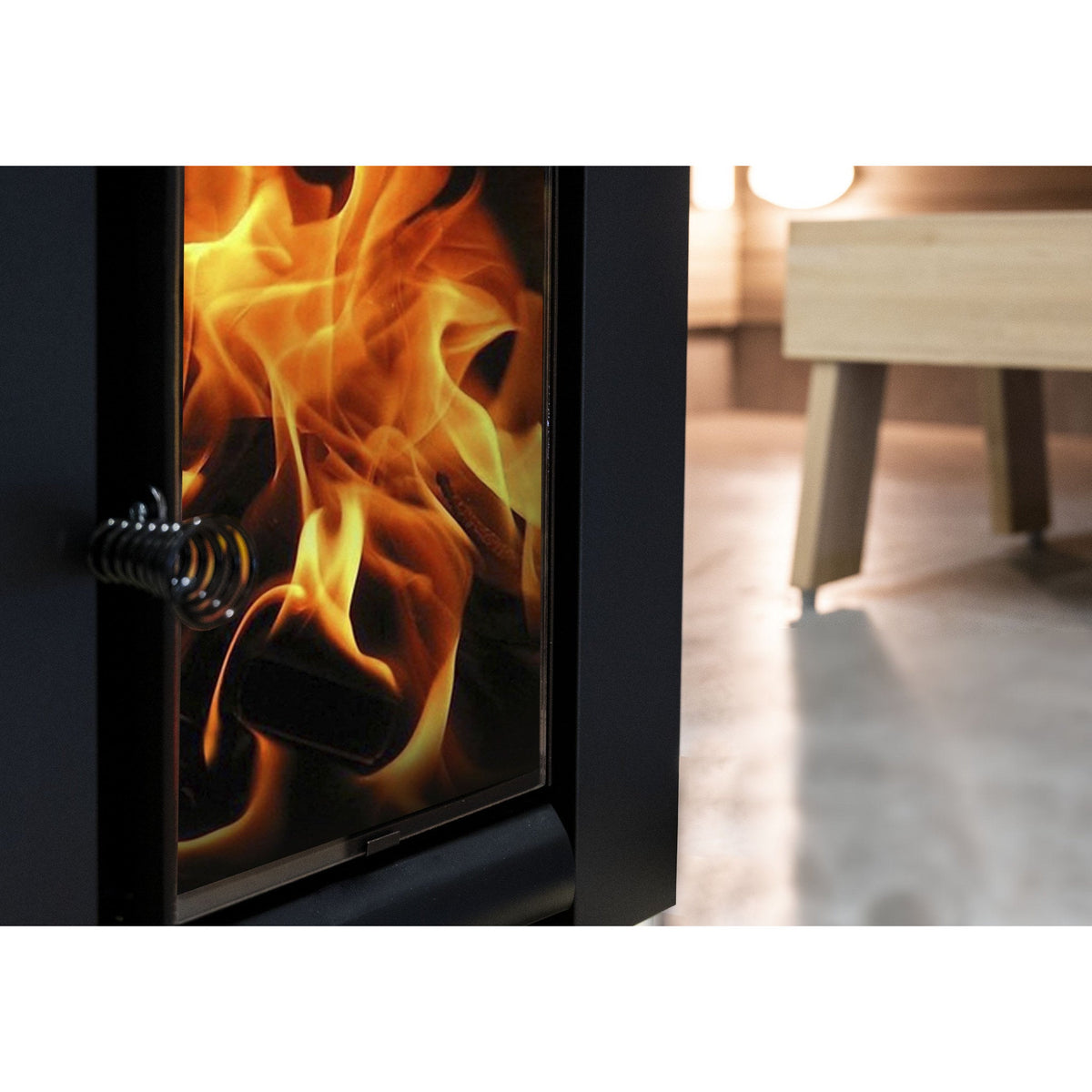 Fire seen through the glass door of a Harvia Linear wood-burning sauna stove