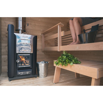 Harvia Pro wood stove in a sauna with bucket, ladle and birch whisk