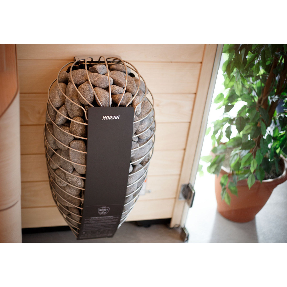 Harvia Spirit sauna heater wall mounted in a home sauna beside a window