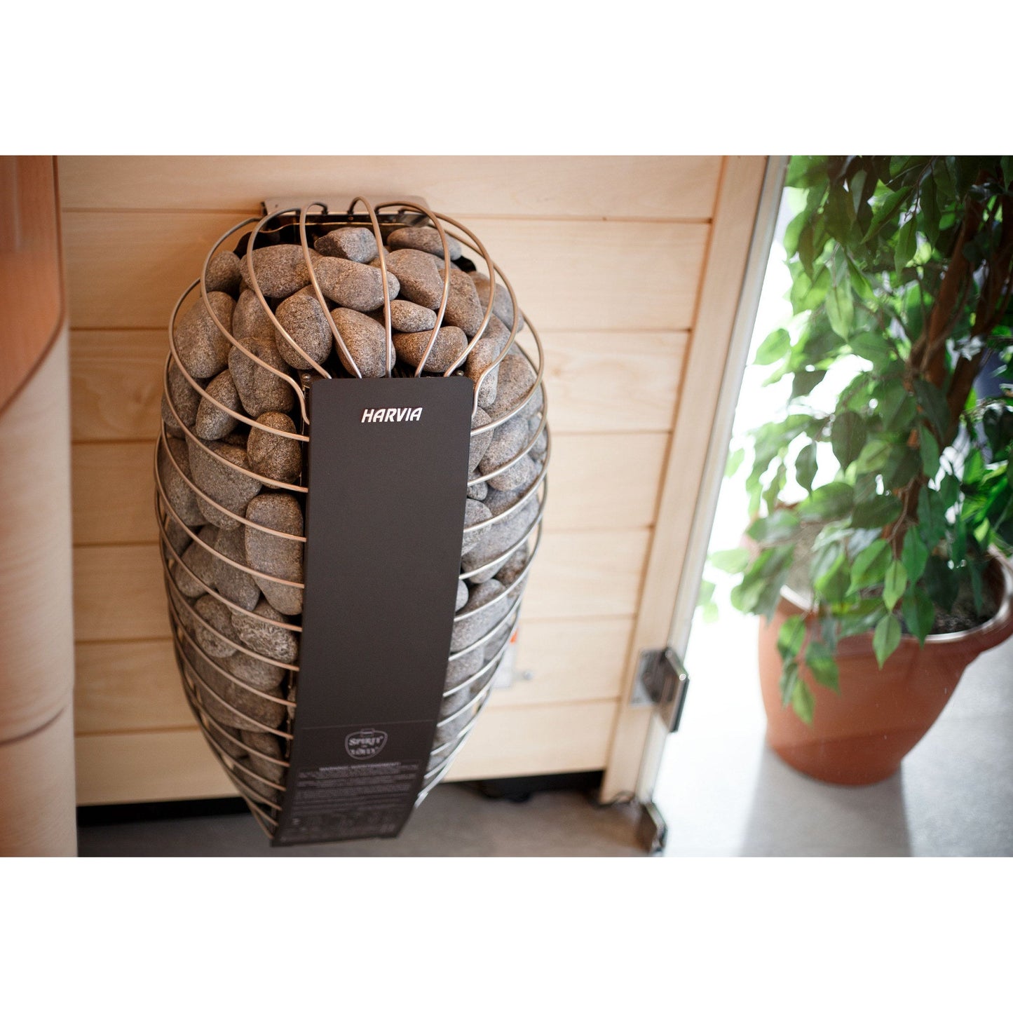 Harvia Spirit sauna heater wall mounted in a home sauna beside a window