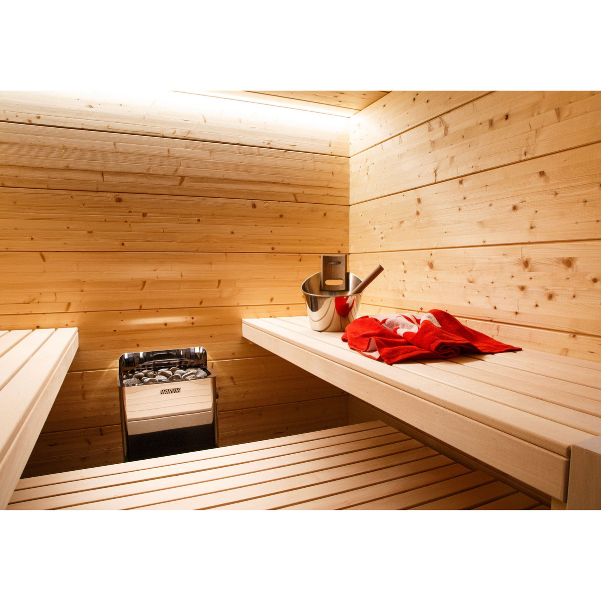 Harvia The Wall stainless steel sauna heater mounted in a finished home sauna