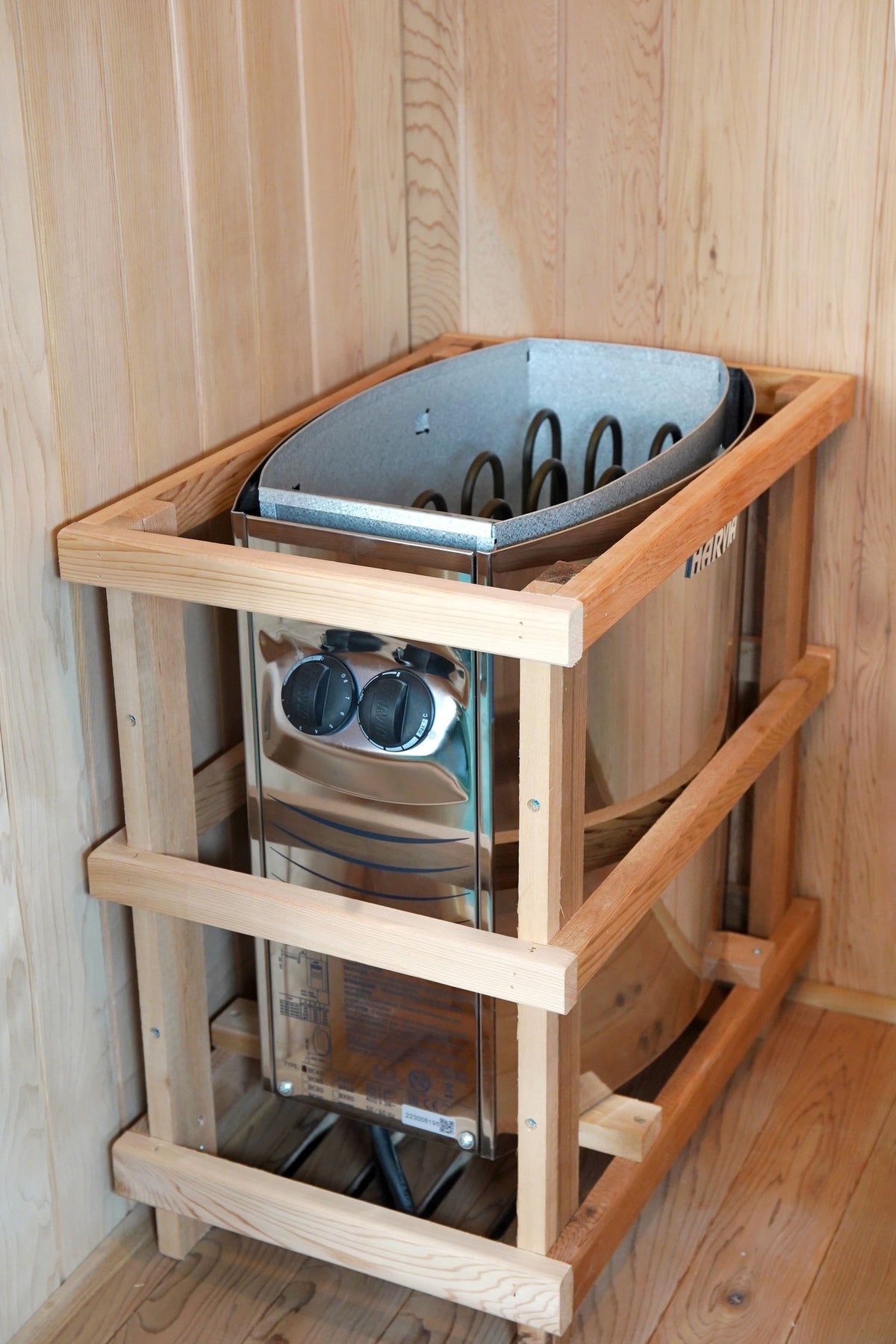 Harvia heater with front control knobs inside its wooden guard rail in the SunRay Aston