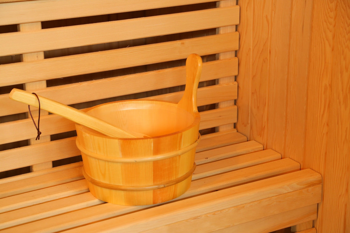 Wooden bucket and ladle on the slatted bench inside the SunRay Baldwin, in front of the backrest