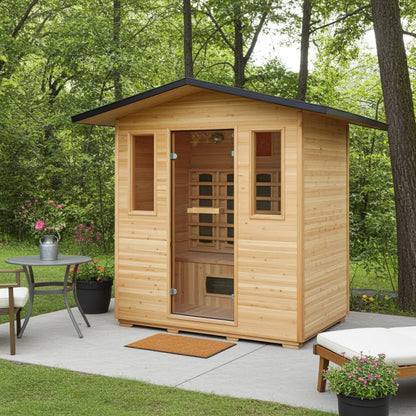 SunRay Cayenne outdoor infrared sauna on a concrete patio among trees, with a bistro table and a lounger