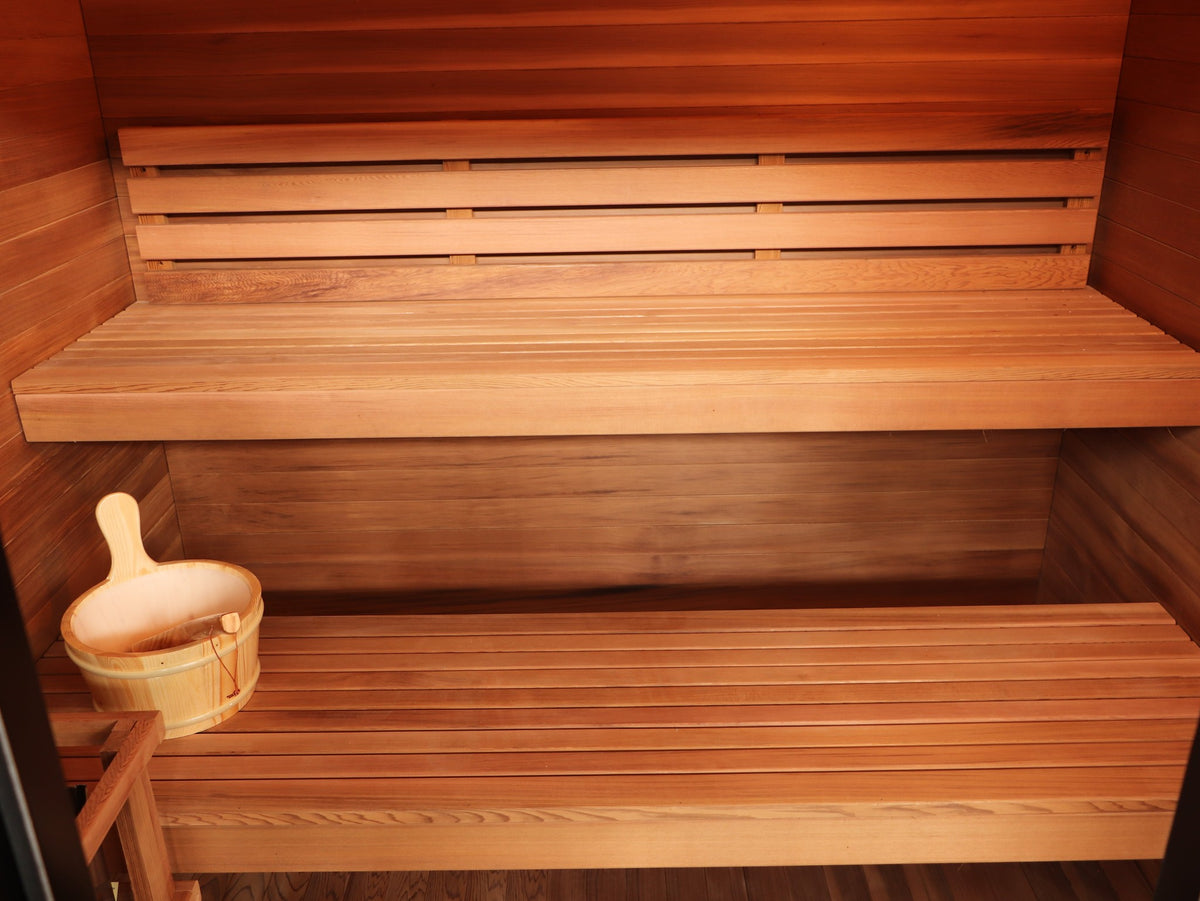 Upper and lower benches with backrest inside the SunRay Cayman, bucket and ladle on the lower bench