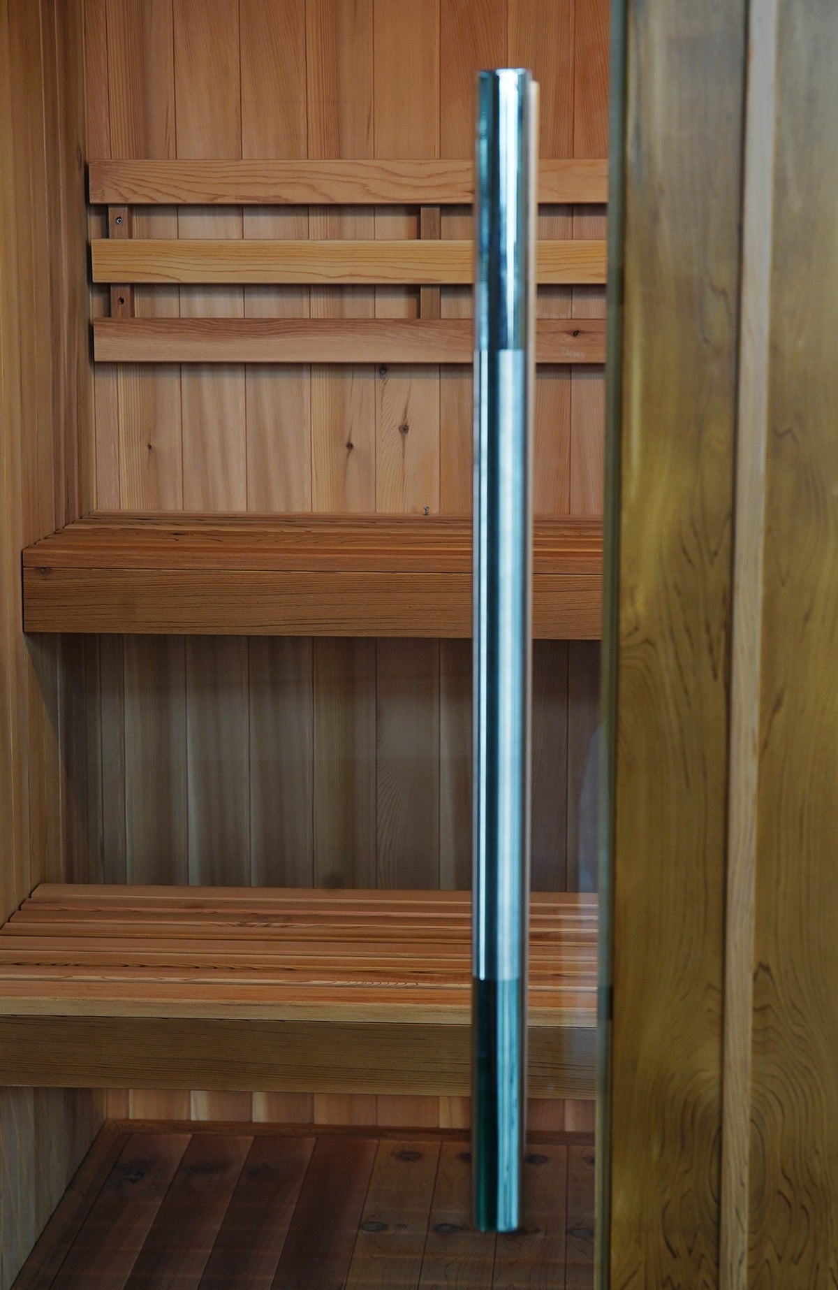 Stainless steel door handle on the SunRay Charleston glass door, two-tier benches behind