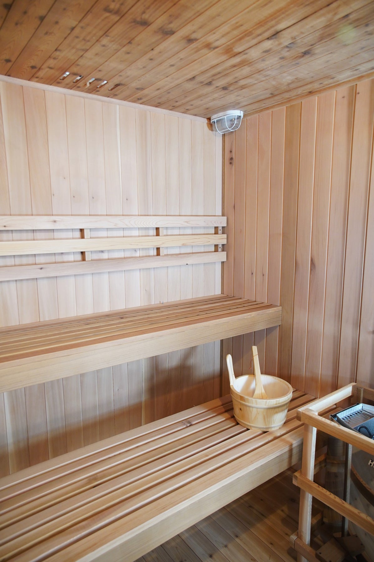Upper and lower benches below the ceiling light and vents inside the SunRay Charleston, bucket on the lower bench