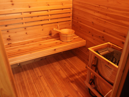 Bench with backrest and bucket, Harvia heater in its wooden guard inside the SunRay Denali