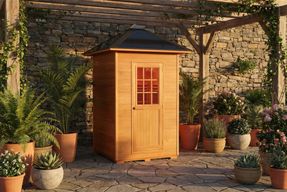 SunRay Eagle outdoor sauna on a stone patio under a pergola, surrounded by potted plants