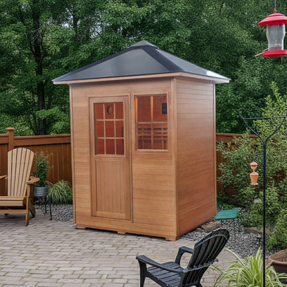 SunRay Freeport outdoor sauna on a paver patio in a fenced backyard with Adirondack chairs