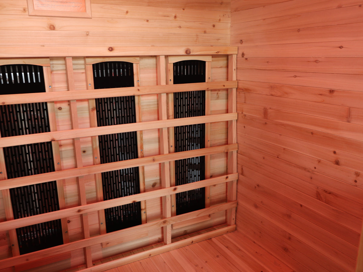 Back corner of the SunRay Grandby interior: infrared heater panels behind the backrest slats, hemlock walls