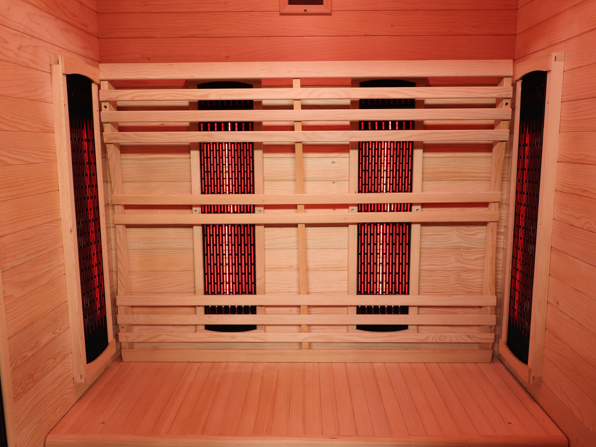 SunRay Logan interior: hemlock bench and back wall with infrared heater panels behind the backrest and on both side walls
