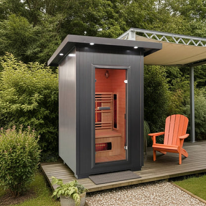 SunRay Logan outdoor infrared sauna on a garden deck beside a shade canopy and an orange Adirondack chair