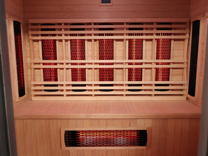SunRay Pacific interior: long hemlock bench with five infrared panels behind the backrest, side panels and one in the bench front