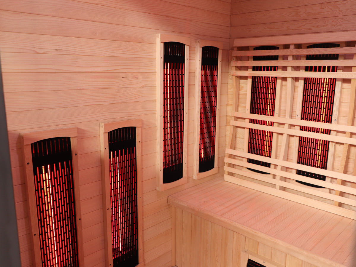 Corner of the SunRay Pacific interior with paired infrared panels on the side wall and the back wall heaters behind the backrest