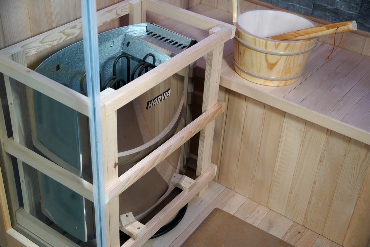 Harvia heater inside its wooden guard next to the bench and bucket in the SunRay Rockledge