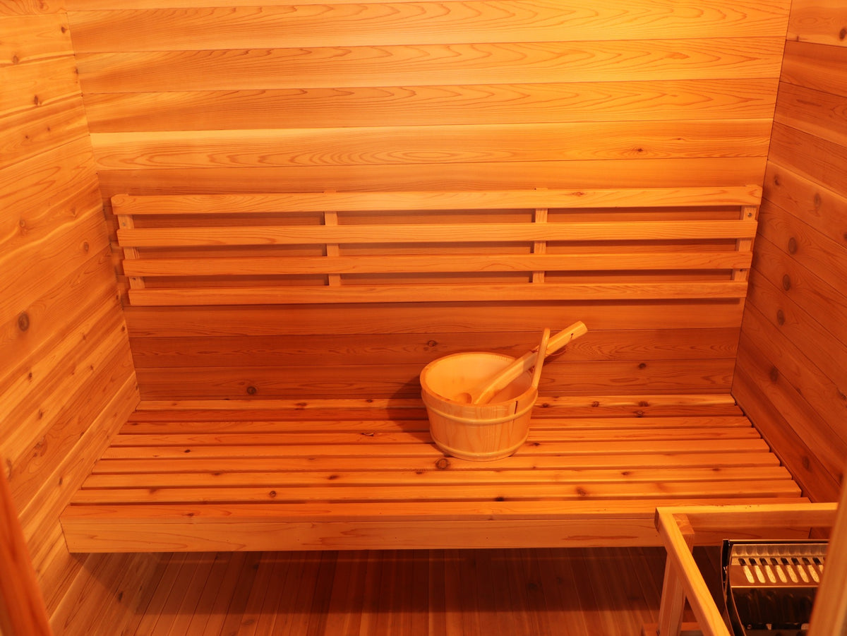 Bench with backrest and bucket across the back wall of the SunRay Seneca, heater guard in the corner