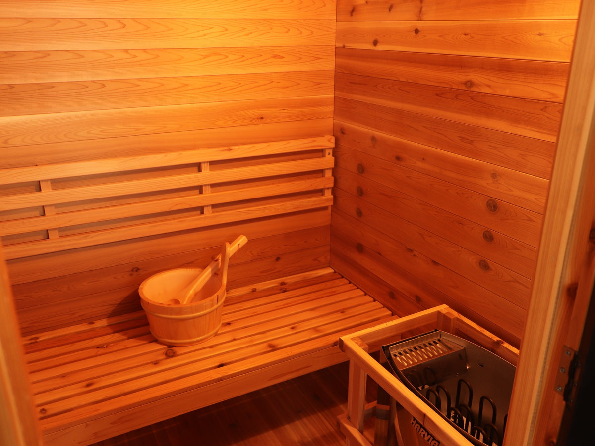 Bench, backrest and Harvia heater in its wooden guard inside the SunRay Seneca