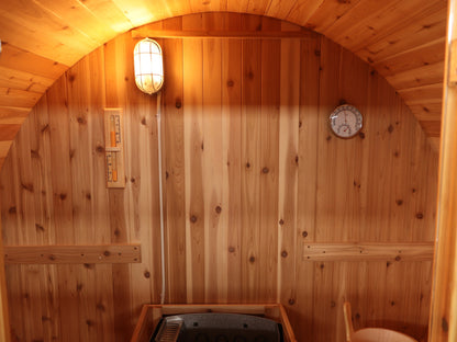 Inside the SunRay Solace: western red cedar back wall with light, sand timer, thermometer and hygrometer above the backrests