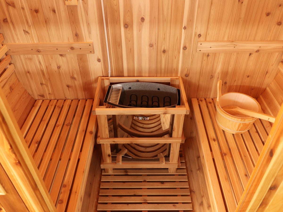 Looking down into the SunRay Solace: heater inside its guard rail between two cedar benches, wooden bucket on the right