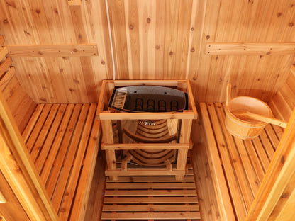 Looking down into the SunRay Solace: heater inside its guard rail between two cedar benches, wooden bucket on the right