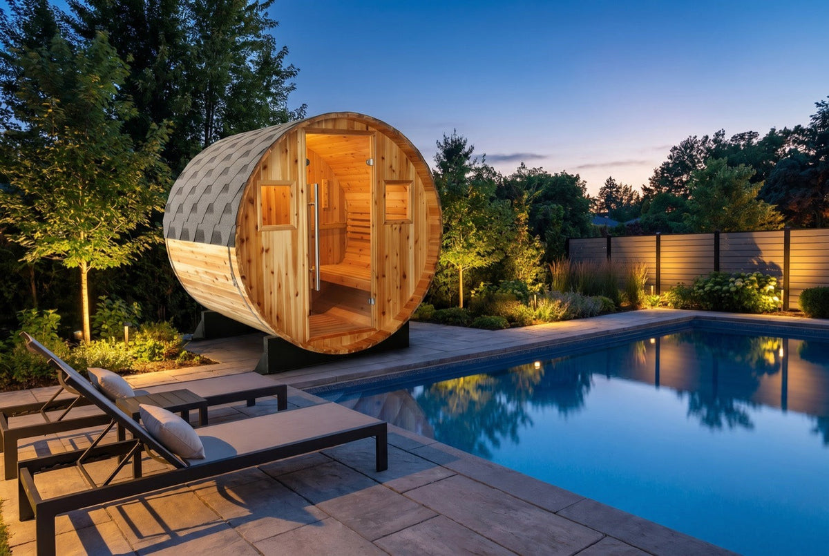 SunRay Solace barrel sauna in western red cedar beside a pool at dusk: glass door between two small windows under the shingled roof, loungers on the pool deck