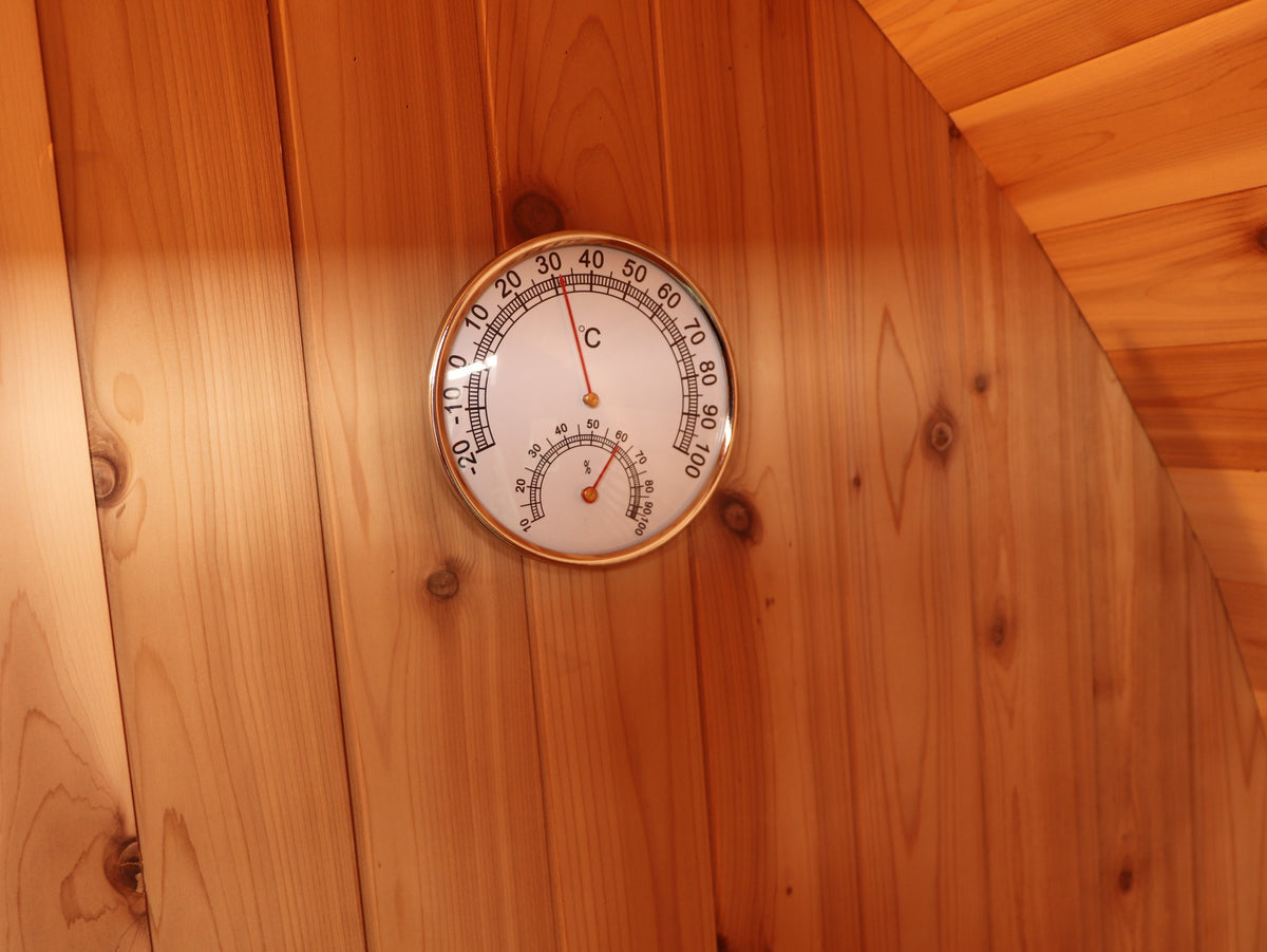 Thermometer and hygrometer dial on the cedar wall inside the SunRay Solace