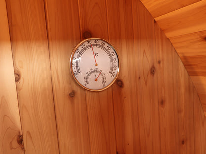 Thermometer and hygrometer dial on the cedar wall inside the SunRay Solace