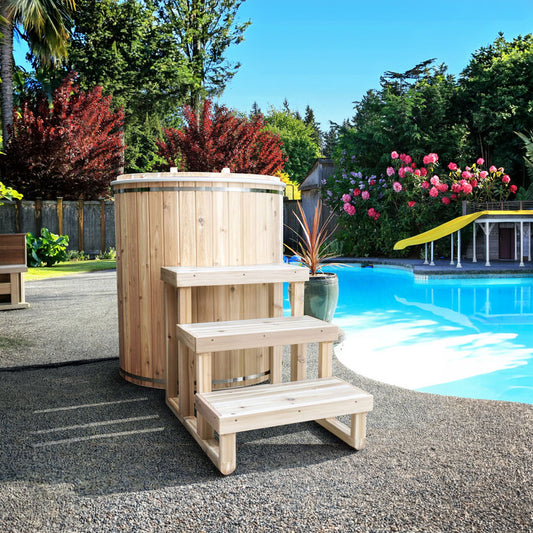 The Baltic Plunge Tub by LeisureCraft beside a backyard pool with three-tier cedar steps