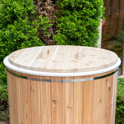 Cedar cold plunge lid fitted on The Baltic Plunge Tub, stainless band and cedar staves visible