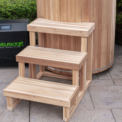Three-tier knotty red cedar steps beside The Baltic Plunge Tub on a patio