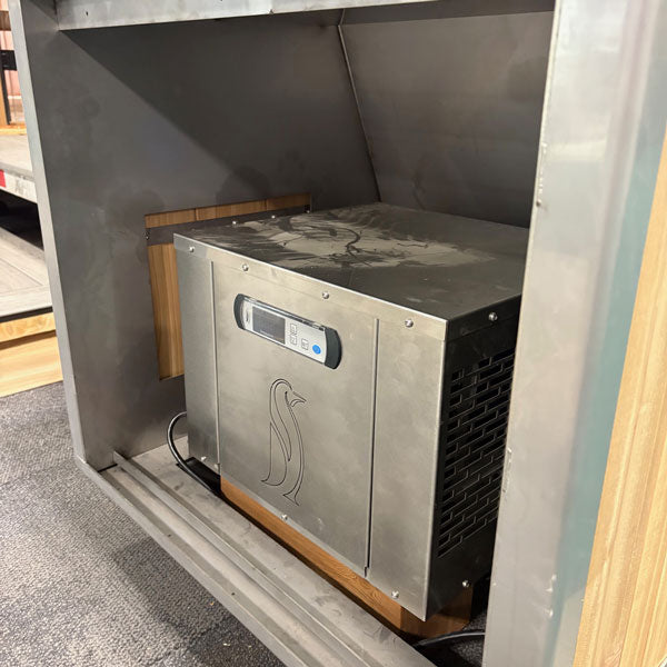 Penguin cold therapy chiller installed inside The Flow Cold Plunge stainless compartment