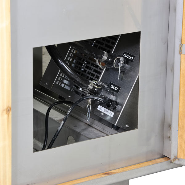 Inlet and outlet hose connections on the chiller inside The Flow Cold Plunge