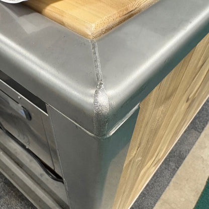 Welded stainless corner and cedar top rail of The Flow Cold Plunge, close up