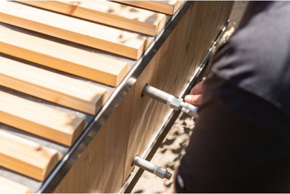 Two chiller fittings through the cedar side wall of The Polar Plunge Tub, roll-up cover slats above