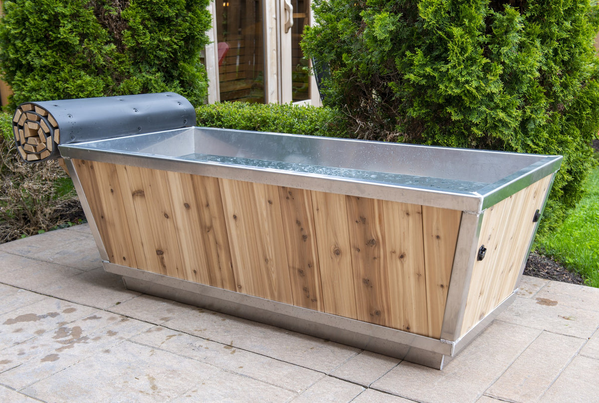 Cold water in The Polar Plunge Tub with cedar cladding and stainless rim, hedge behind