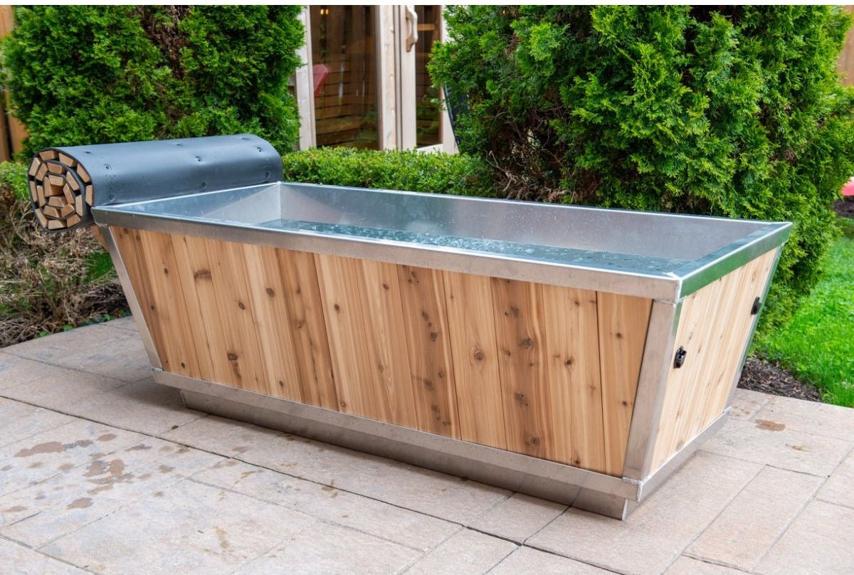 Cold water in The Polar Plunge Tub with cedar cladding and stainless rim, hedge behind