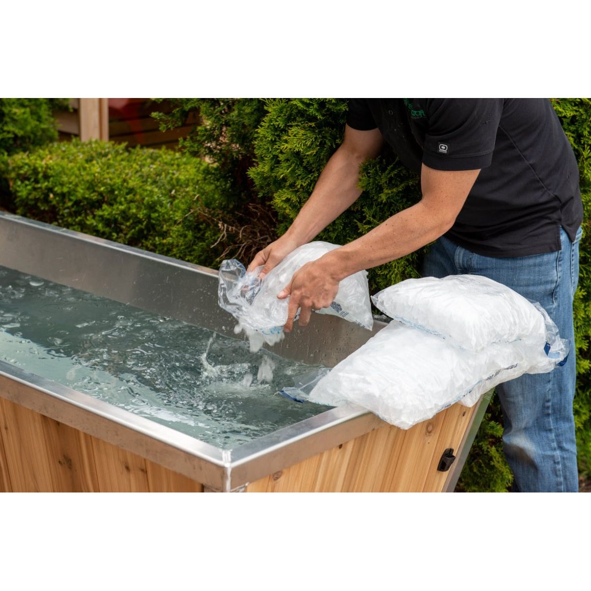 Adding bagged ice to The Polar Plunge Tub during setup