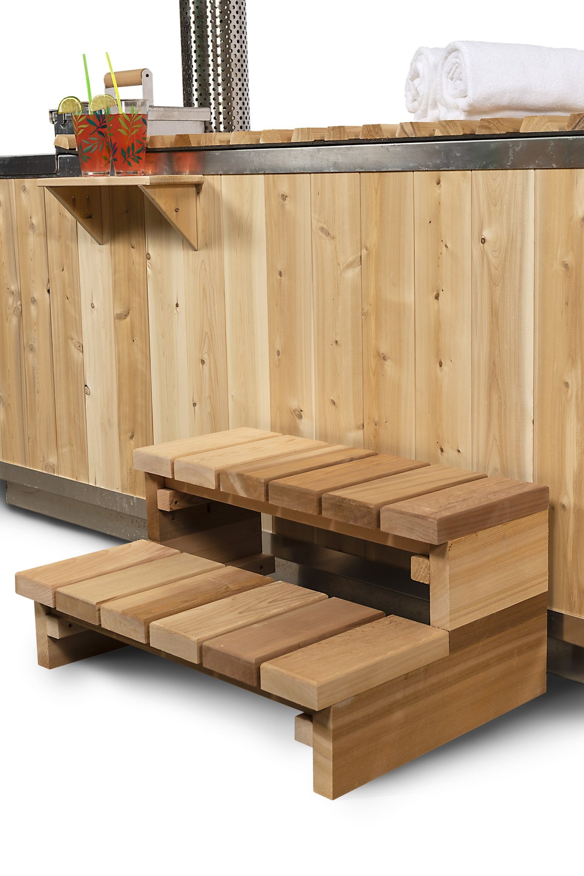 Two tier cedar step and the drink shelf above it, both optional accessories, against the vertical cedar skirt of the Starlight hot tub.