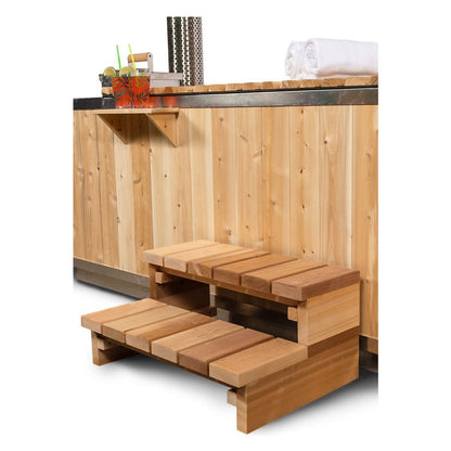 Two tier cedar step and the drink shelf above it, both optional accessories, against the vertical cedar skirt of the Starlight hot tub.