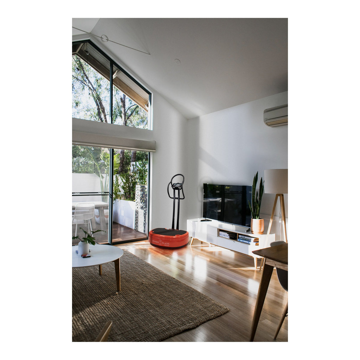 Power Plate MOVE with the MOVE Stability Bar fitted, standing in a living room