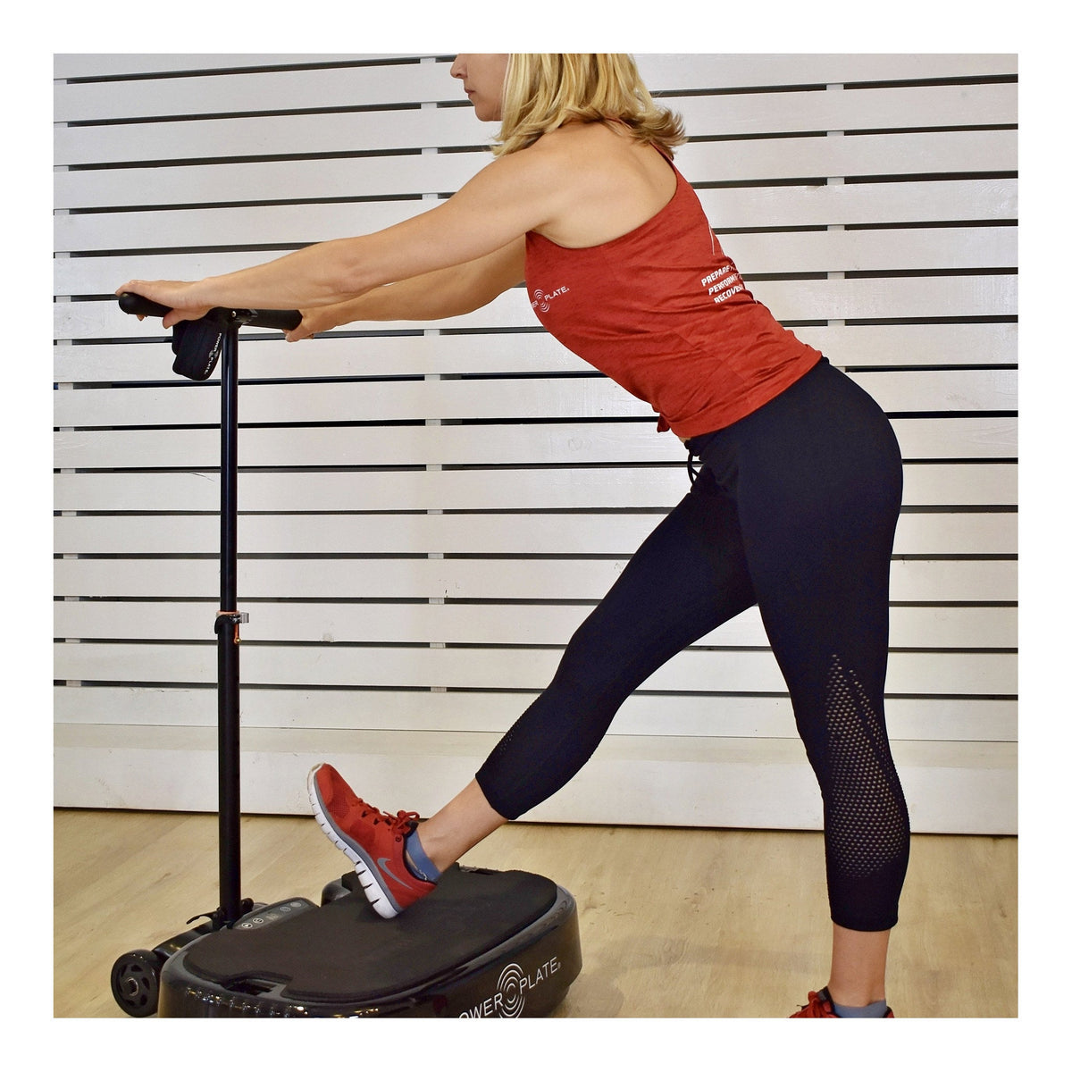 Personal Power Plate Stability Bar handle held during a standing calf stretch